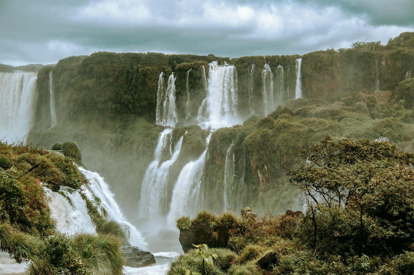 waterfalls under cloudy sky