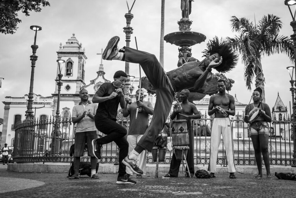 Grayscale photo of people dancing on the street