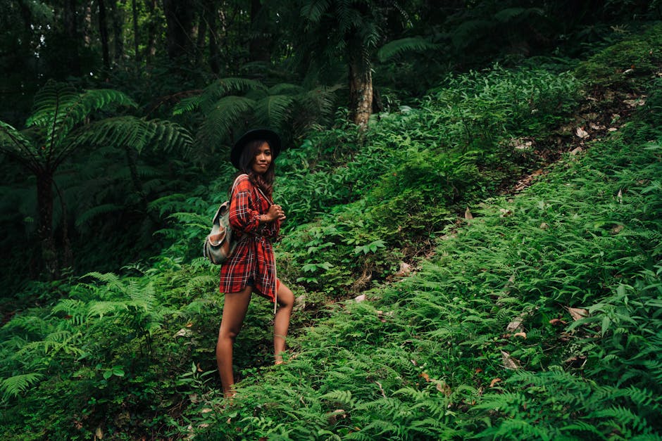 hiker with binoculars in the jungle