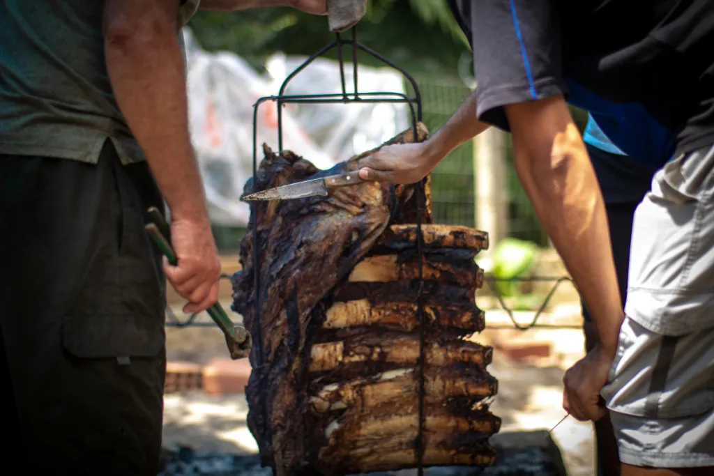 Two men and grilled beef ribs