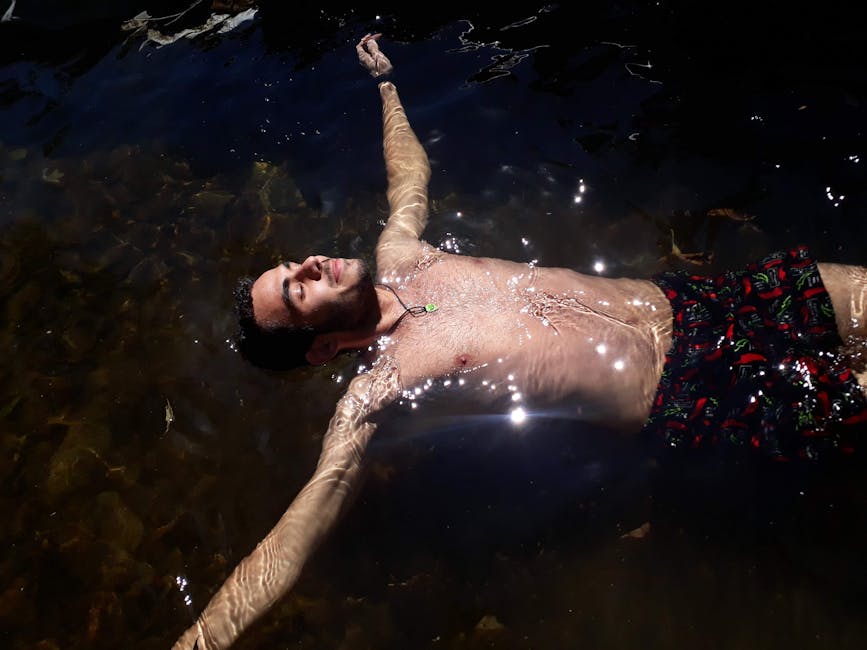 person floating clear blue spring in Brazil