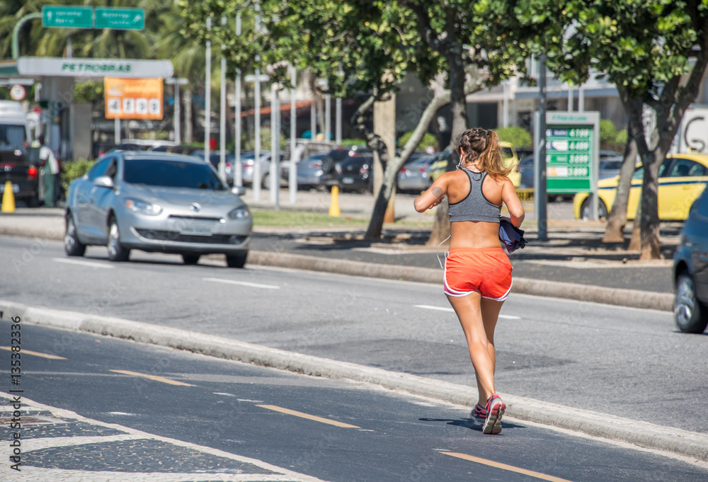 woman walking copacabana beachfront brazil