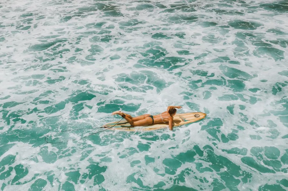 surfer paddling small peeling wave in Brazil