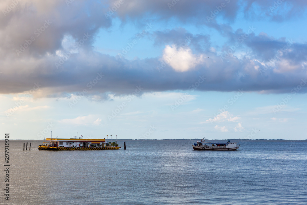 boat approaching riverbank at dawn in Brazil