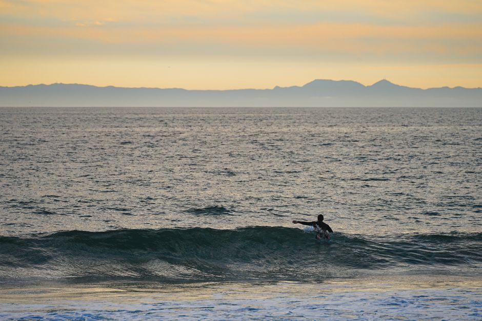 surfer paddling Campeche shore in Brazil