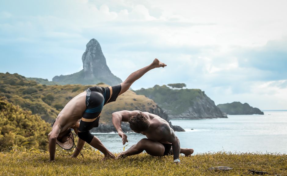 students practicing capoeira on beach in Brazil