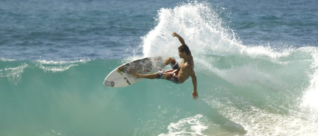 surfer catching wave Praia Mole in Brazil