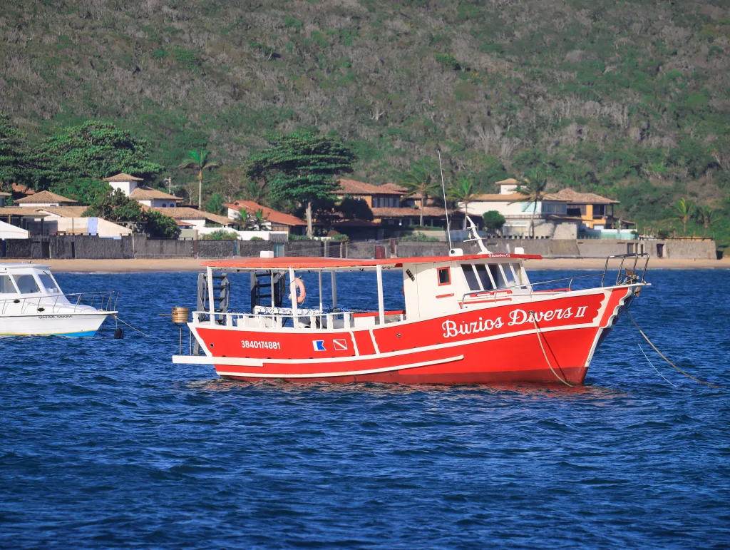 Red dive boat at buzios coastline